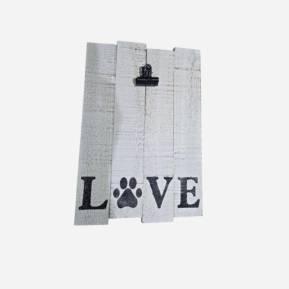 White wooden "LOVE" sign with black paw print, featuring a clip for photos